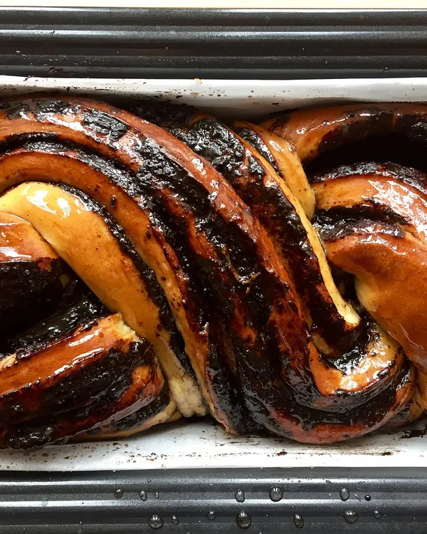 Chocolate babka with dark swirls in its baking pan