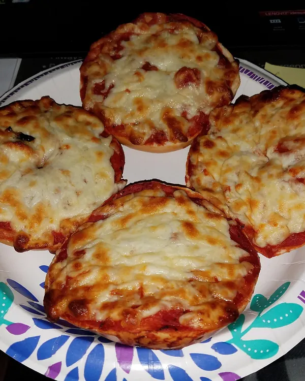 Bagel halves baked with tomato sauce and cheese
