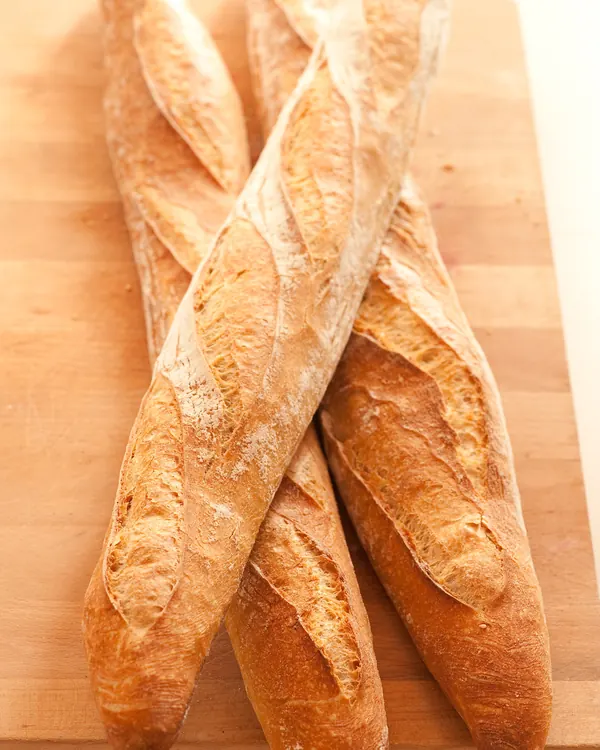Three baguettes on a wooden board