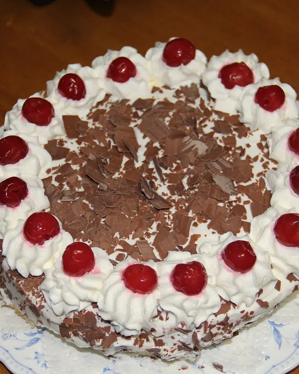 Black Forest cake with cream rosettes, cherries and chocolate shavings