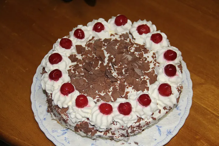 Black Forest cake with cream rosettes, cherries and chocolate shavings
