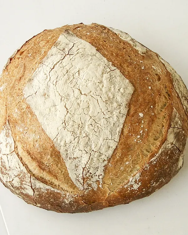 Round crusty loaf dusted with flour