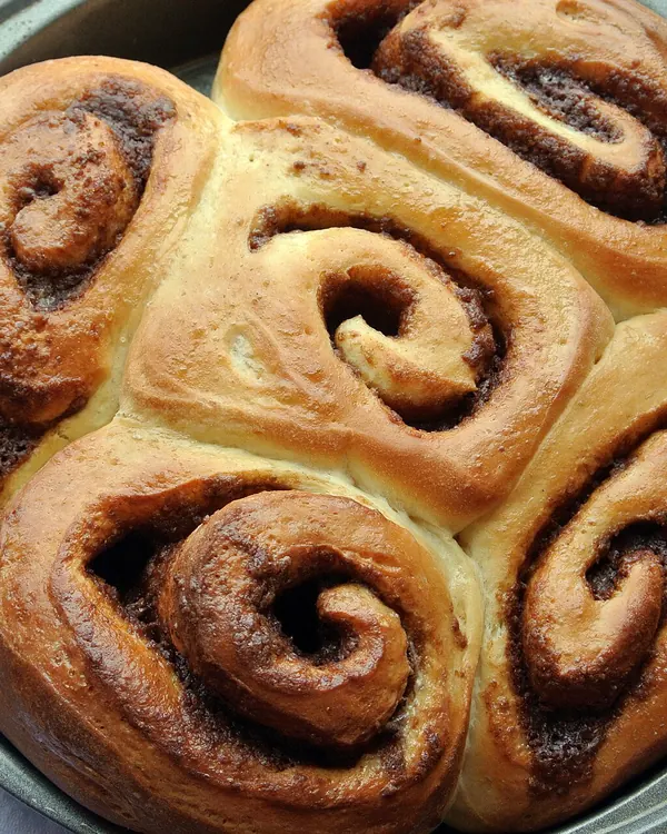 Cinnamon buns baked together in a round pan