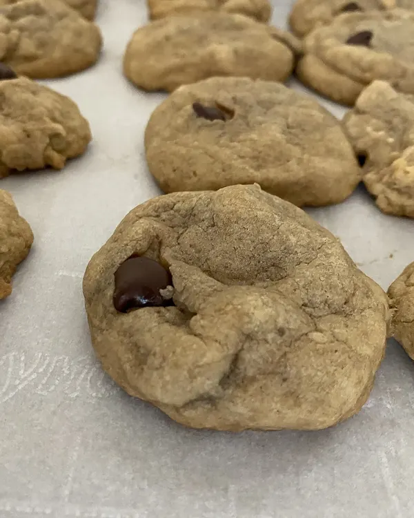 Chocolate chip cookies on baking parchment