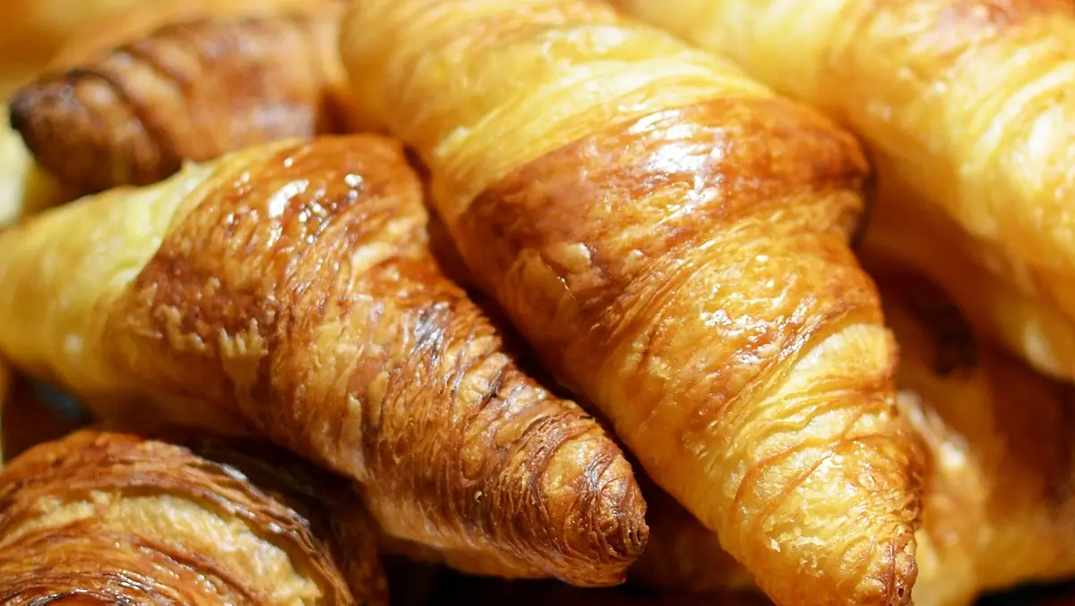 Golden butter croissants piled together