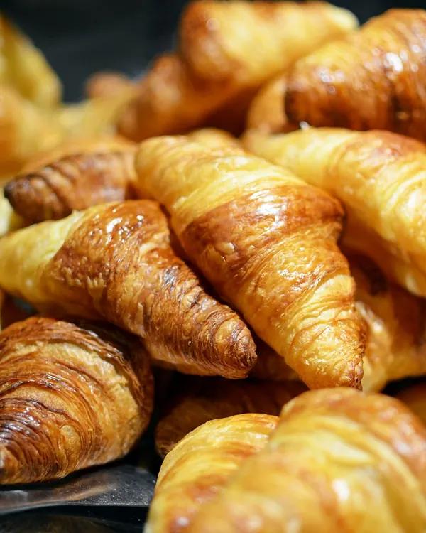 Golden butter croissants piled together