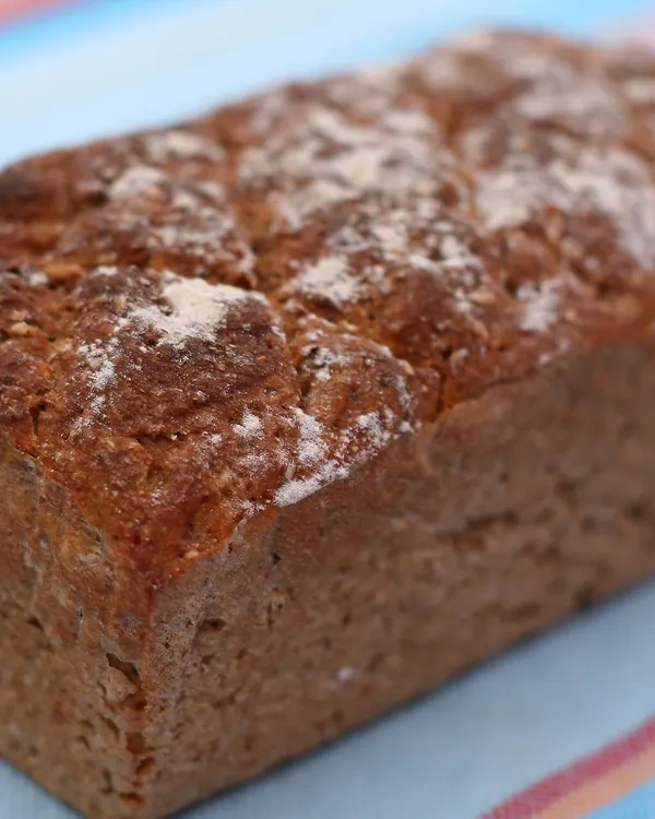 Loaf of rye bread on a striped cloth