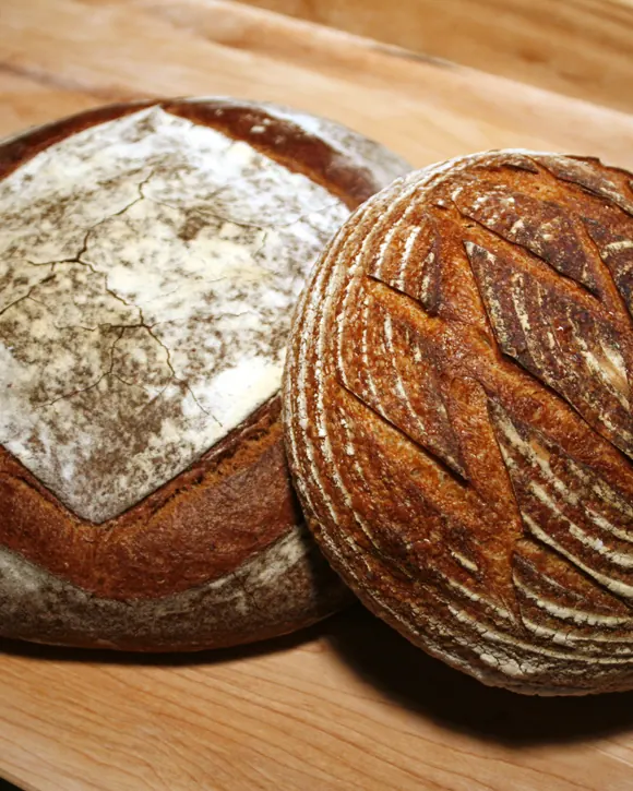 Two round sourdough loaves with scored crusts