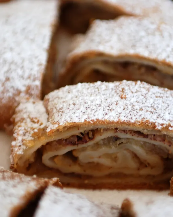 Slices of apple strudel dusted with powdered sugar