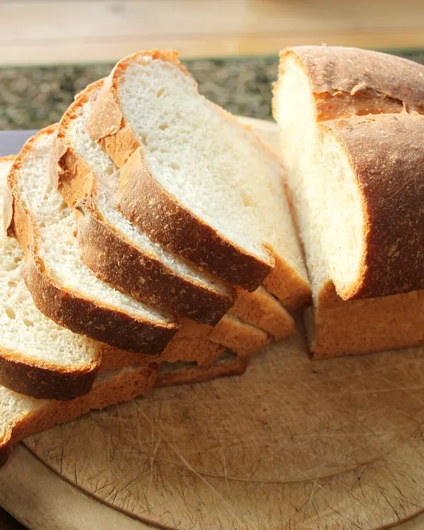 Sliced white tin loaf on a round board